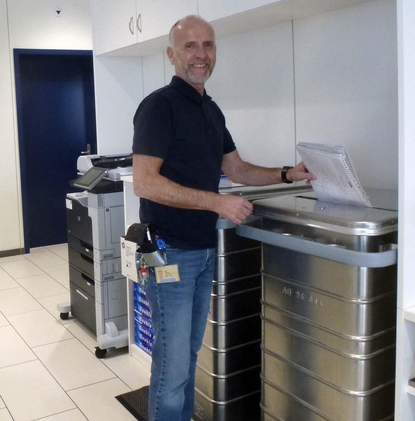 An employee recycles paper